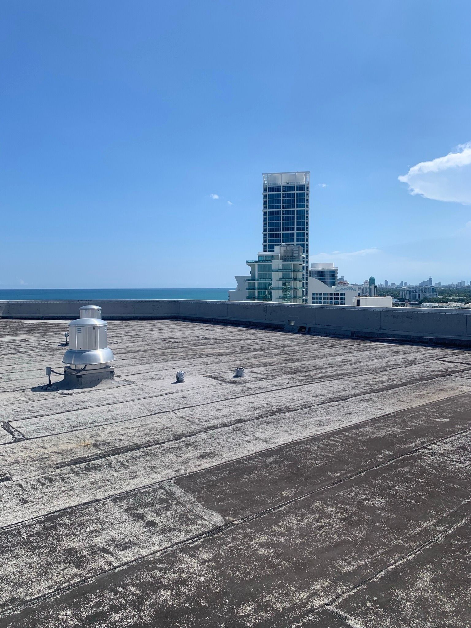 A view of the ocean from the roof of a building.