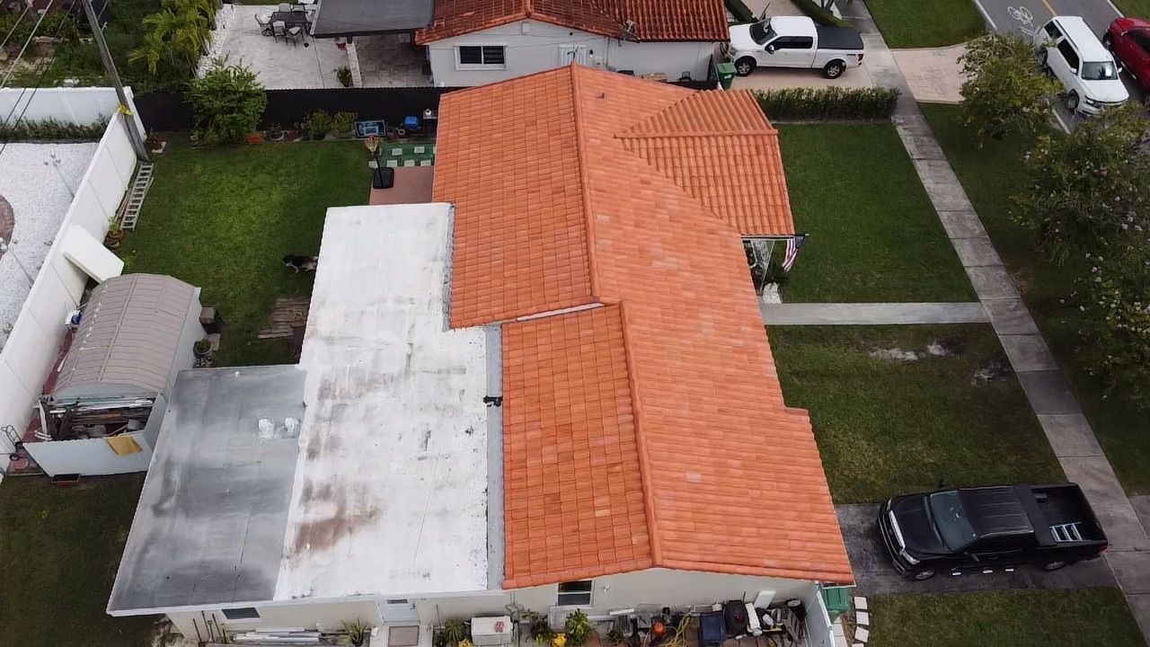 An aerial view of a house with a red tile roof.