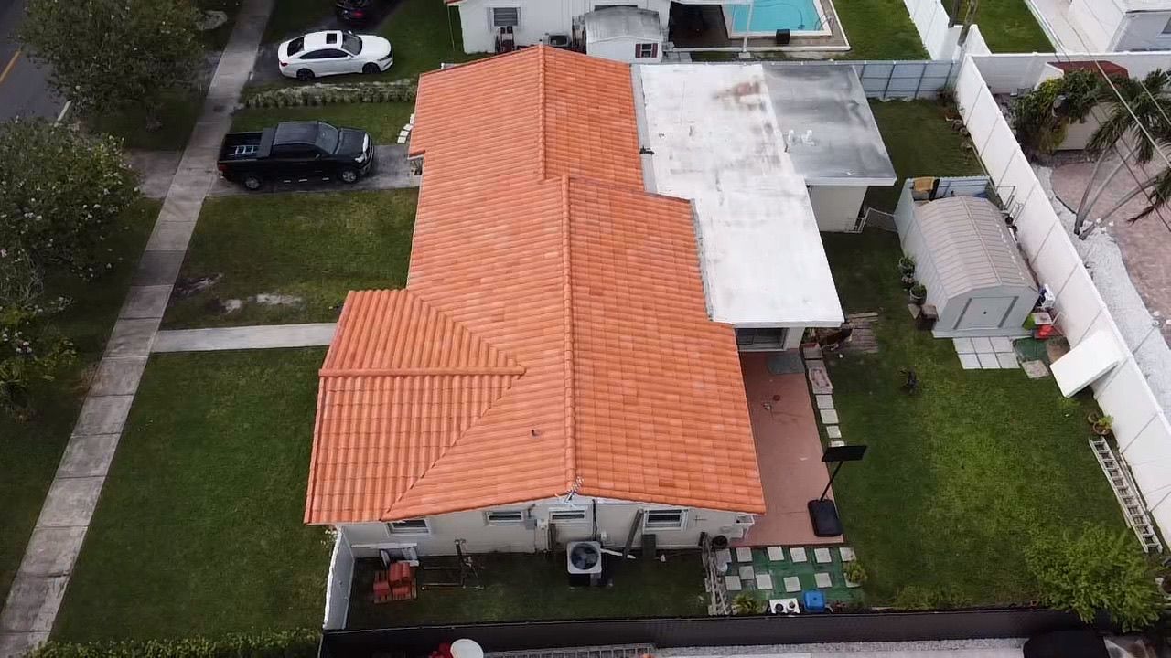 An aerial view of a house with a red tile roof.