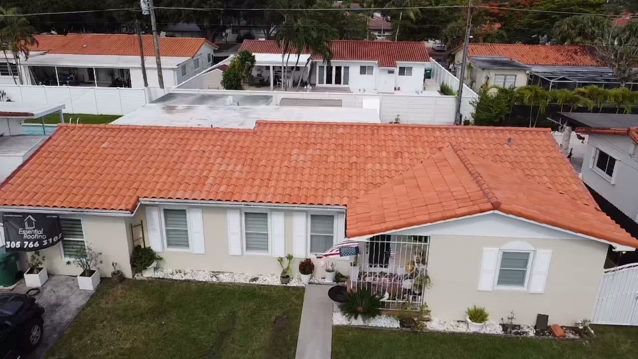 An aerial view of a house with a red tile roof.
