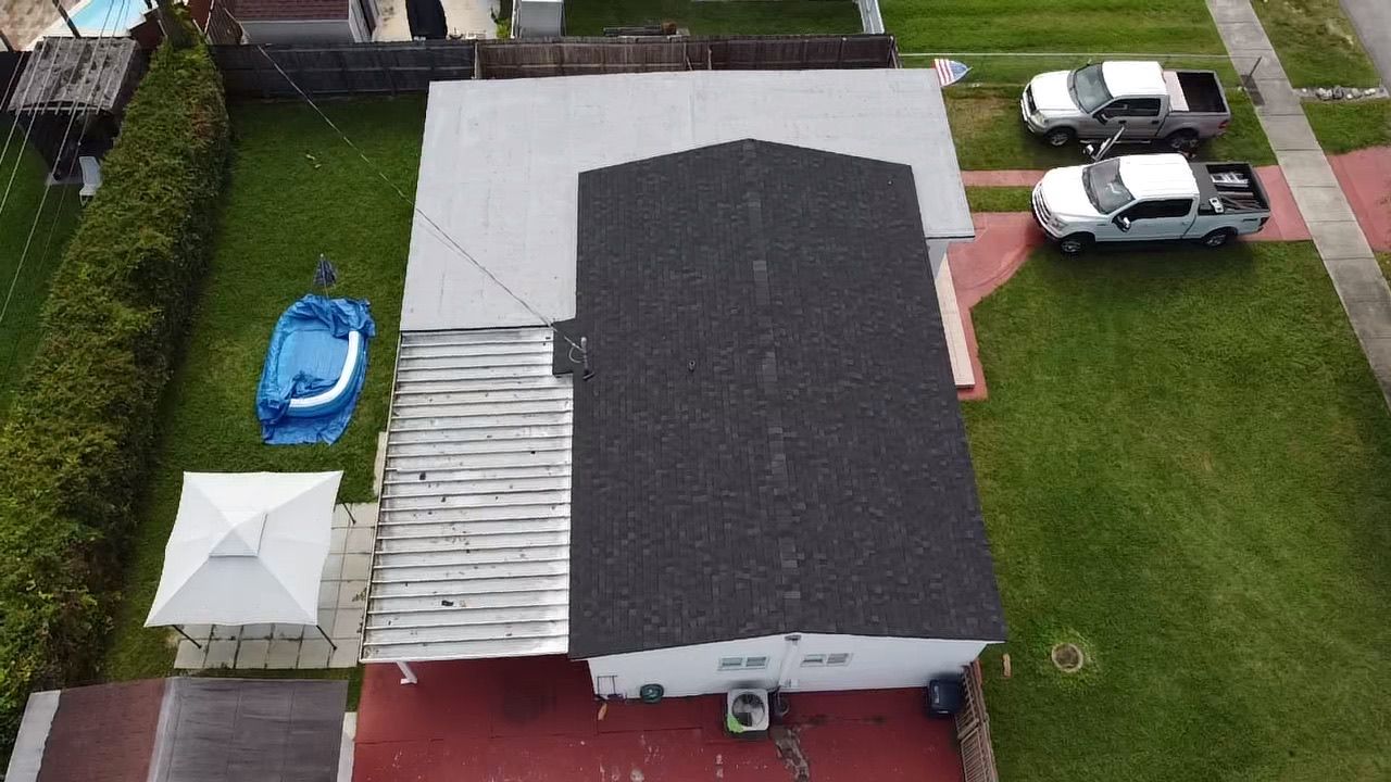 An aerial view of a house with a pool in the backyard.