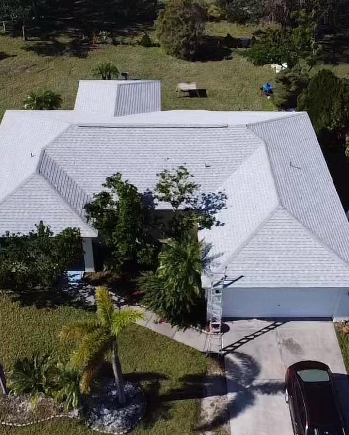 An aerial view of a house with a white roof