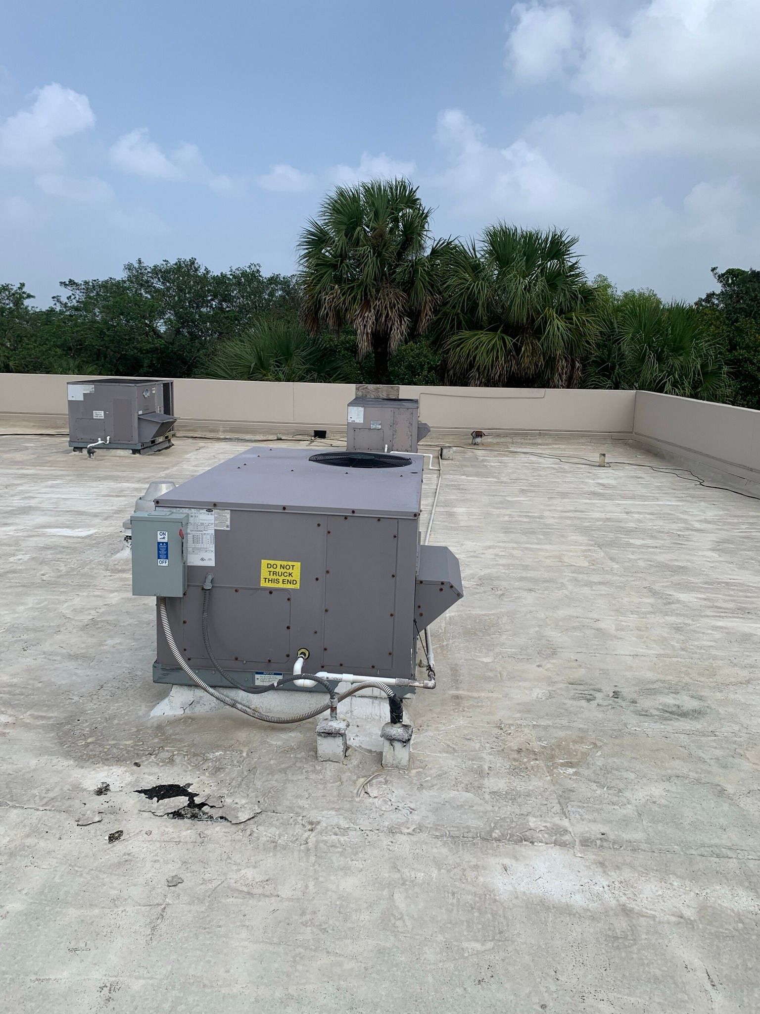 A gray box with a yellow sticker on it that says 