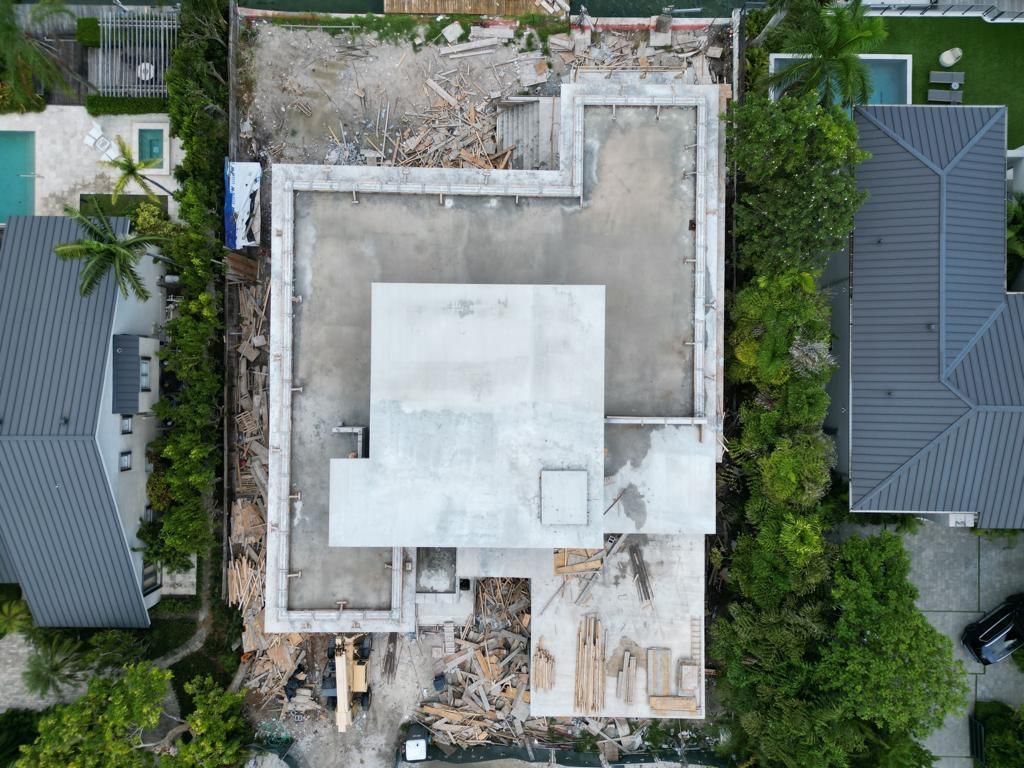 An aerial view of a house under construction in a residential area