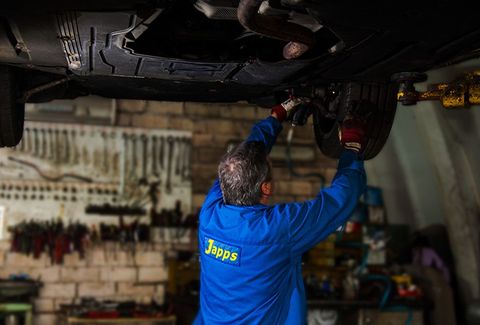 Repairs specialist fixing car