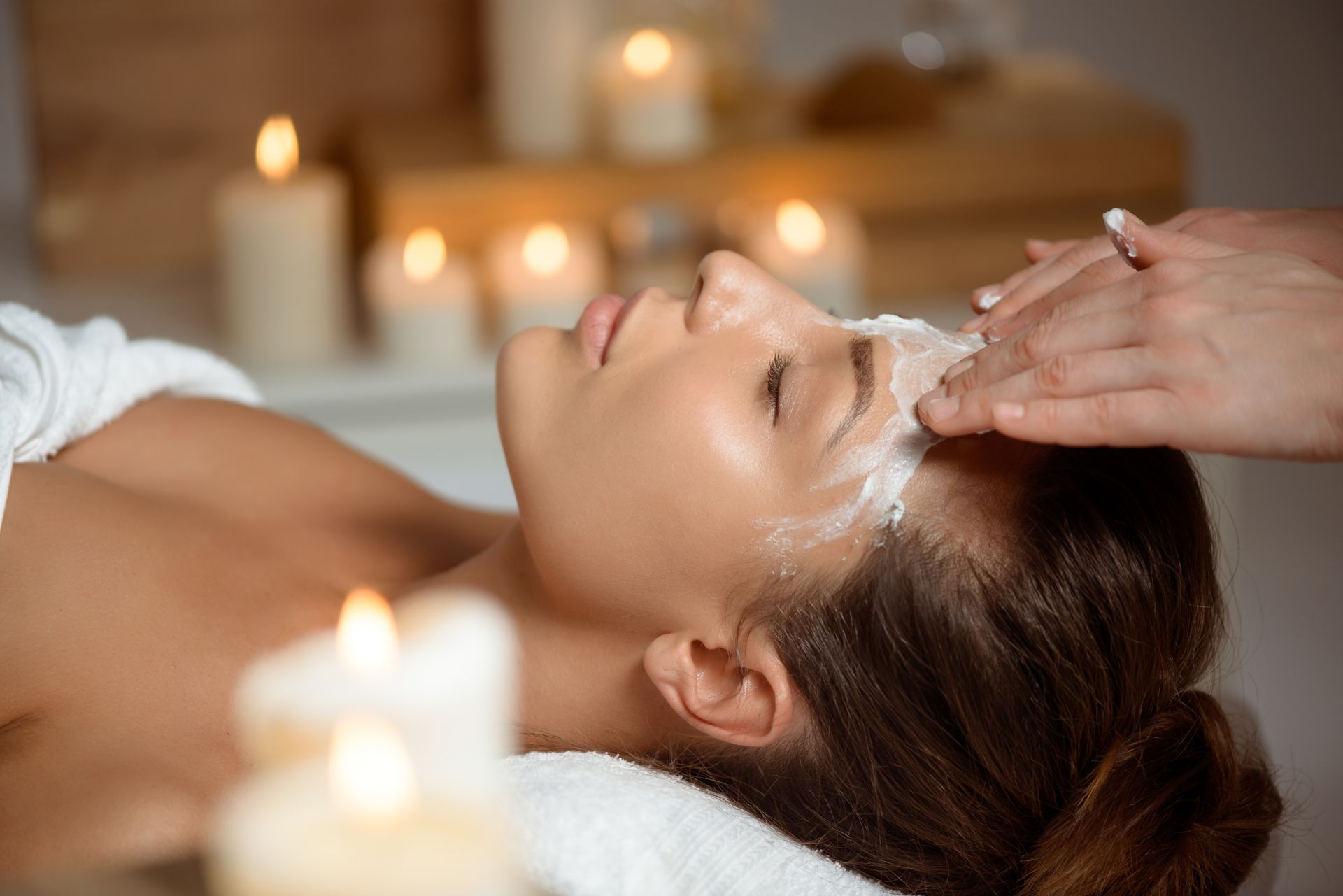 A woman is getting a facial treatment at a spa.