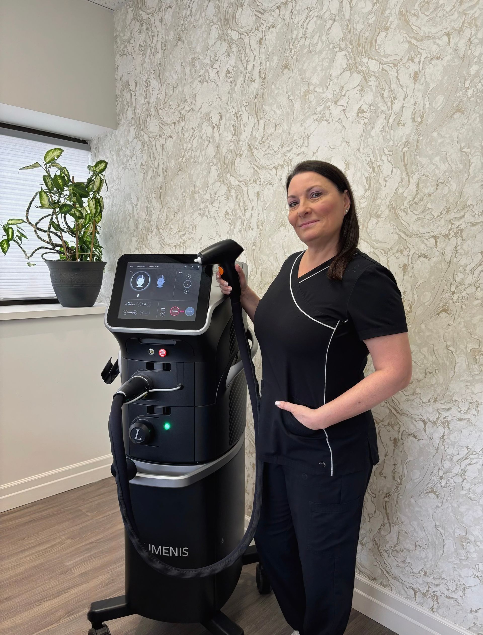 A woman is standing next to a machine in a room.