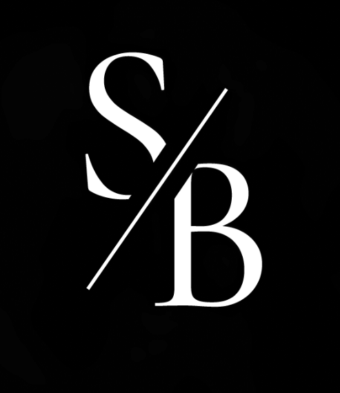 A black circle containing the white letters 