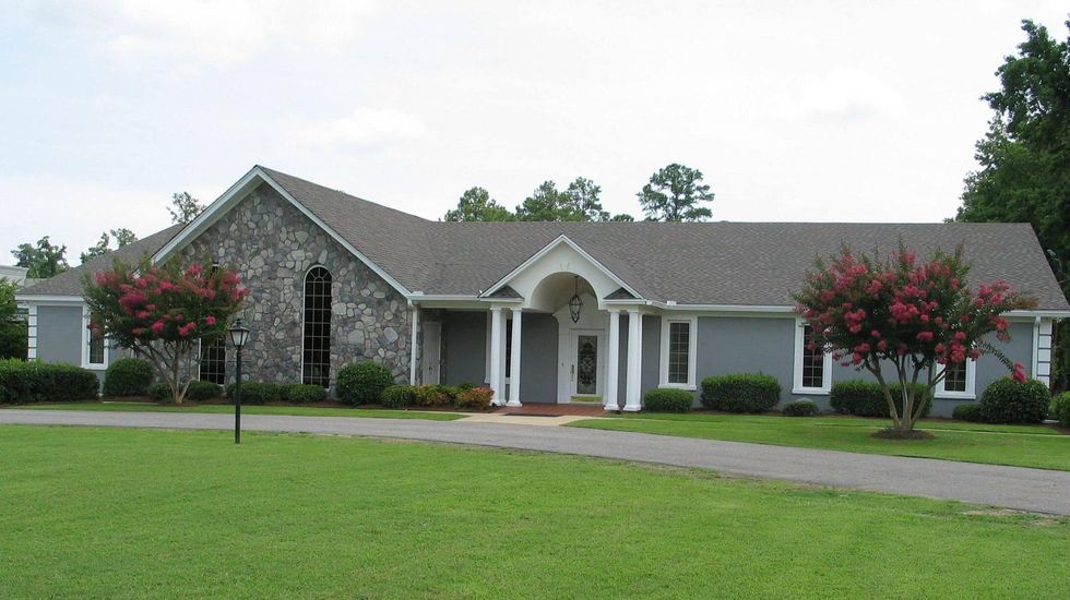 A large office building with a lot of windows on a sunny day.