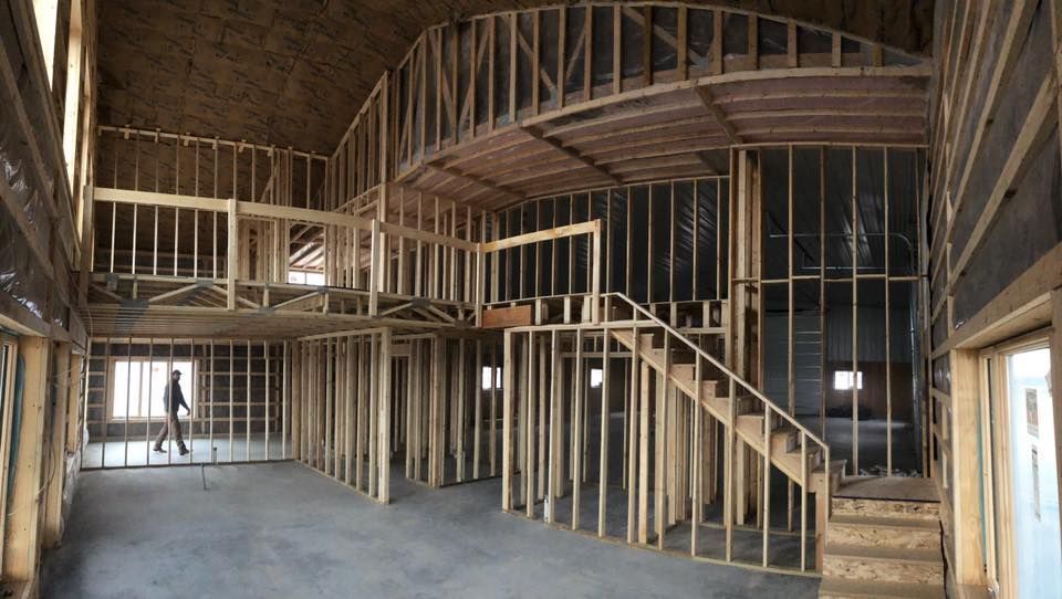 A large room with a staircase in the middle of it is being built.