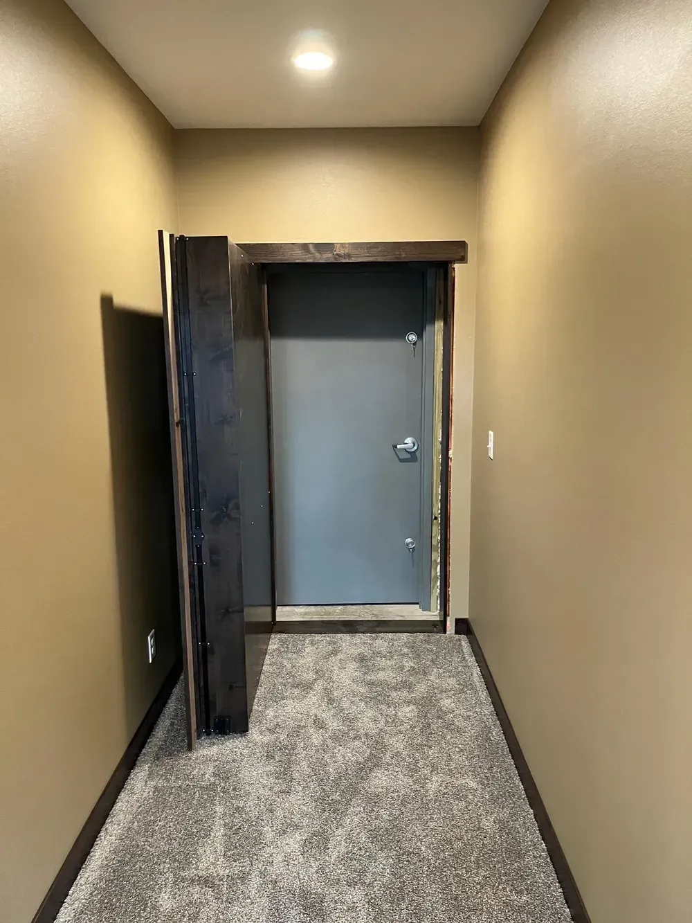 A hallway with a door in the middle of it.