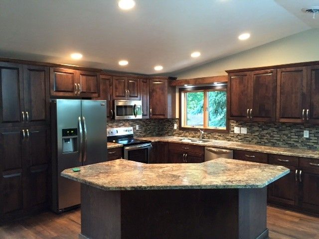 A forklift is parked in front of a house under construction.