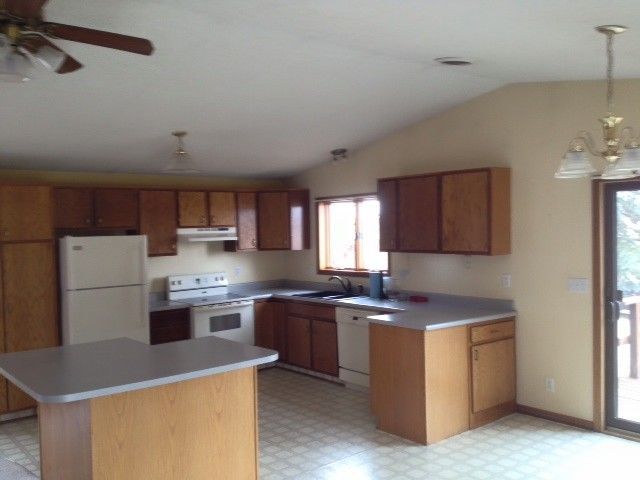 A large wooden structure is being built in a field.