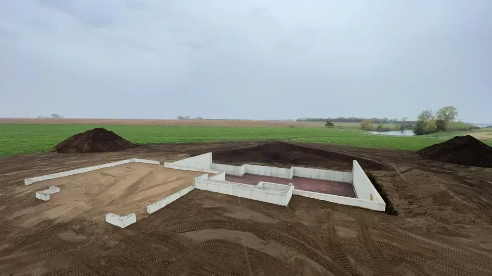 A large pile of dirt is sitting in the middle of a field.