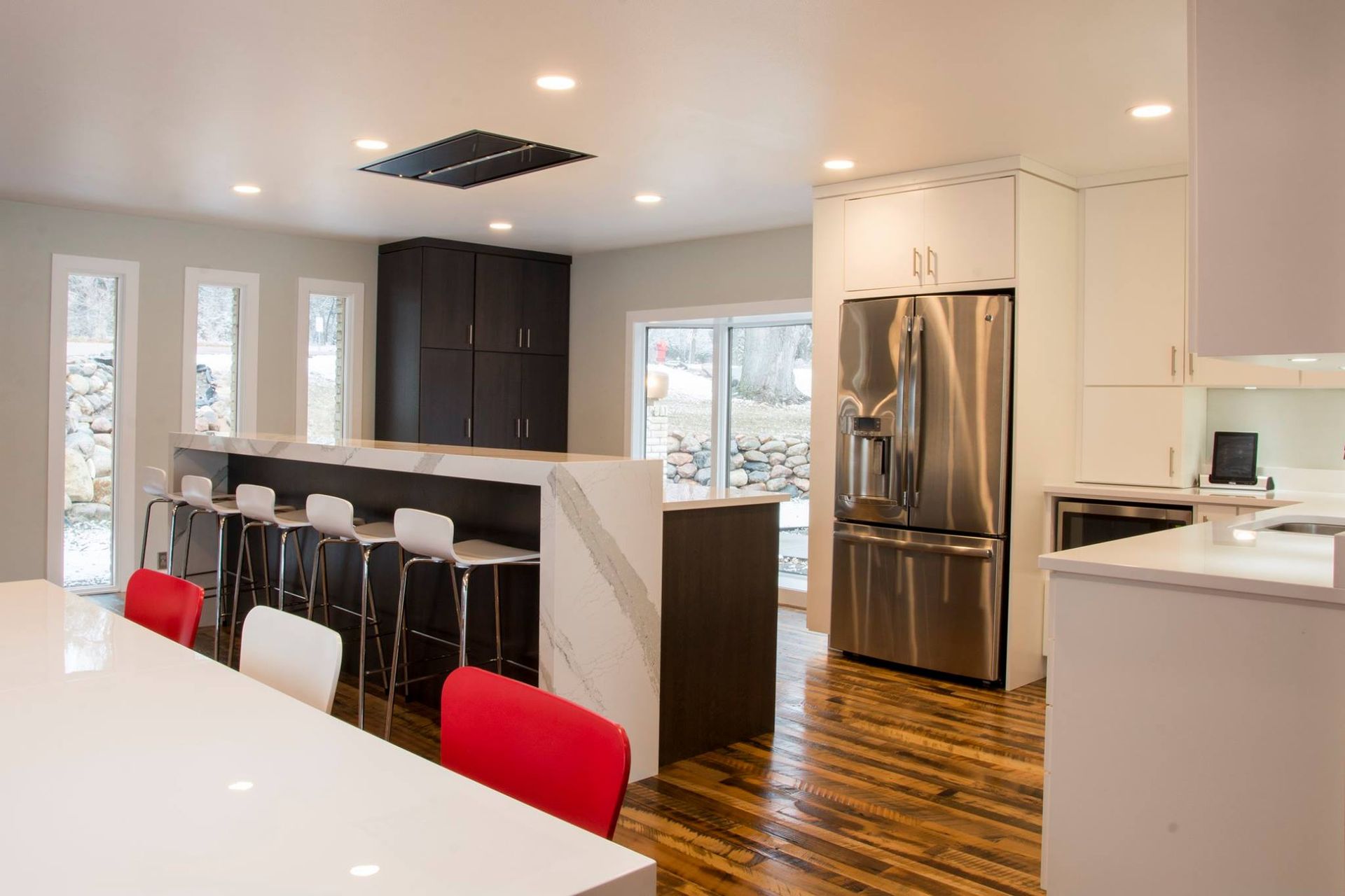A kitchen with gray cabinets and a black oven