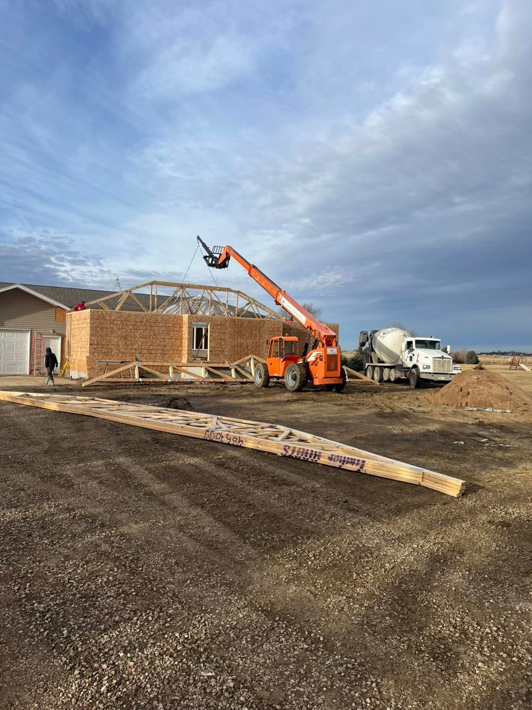 A living room with a fireplace and a flat screen tv on the wall.