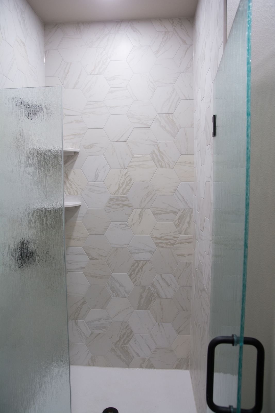 A bathroom with a toilet , sink , bathtub and shower.