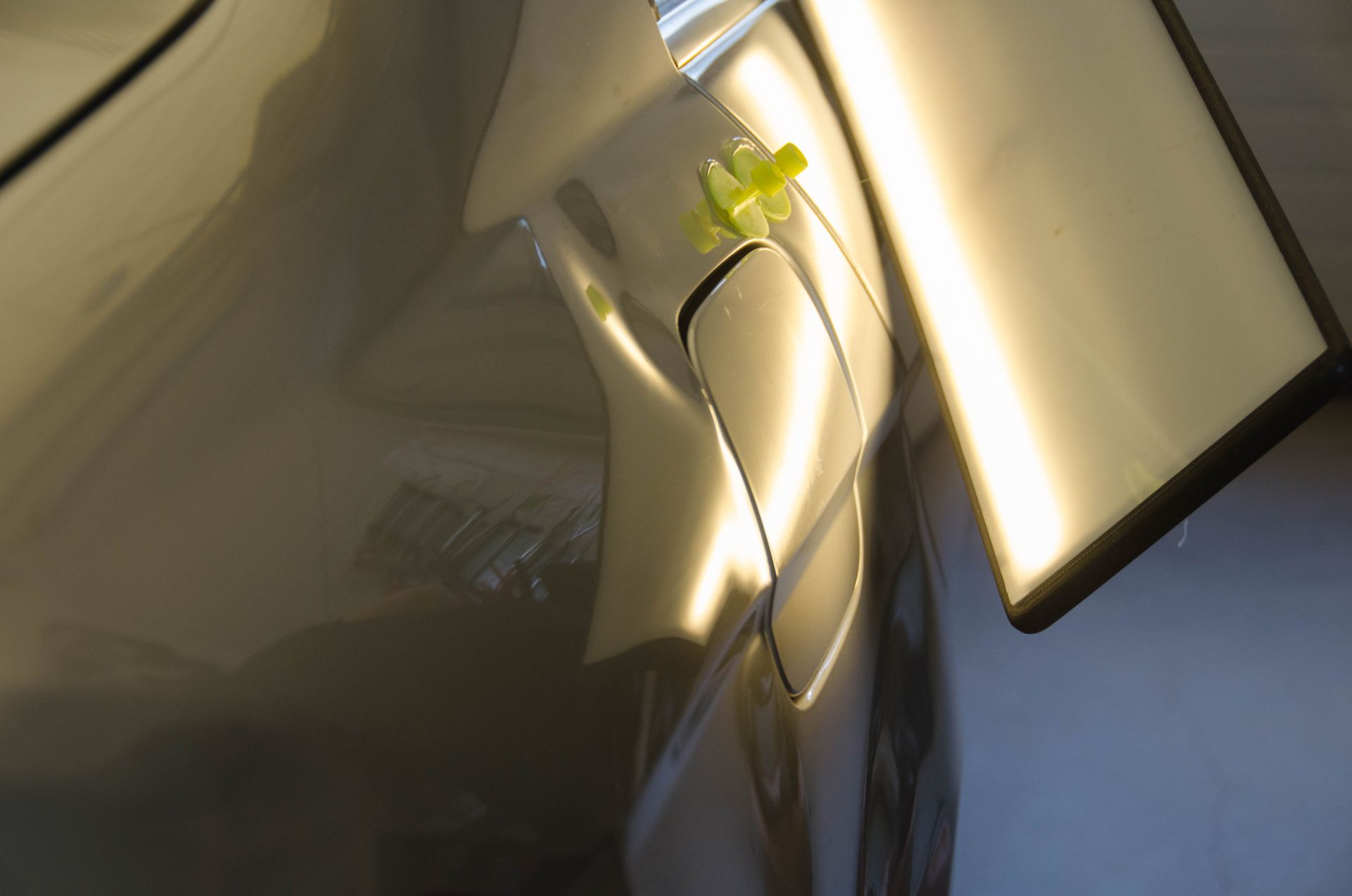 A close up of a car with a yellow sticker on it