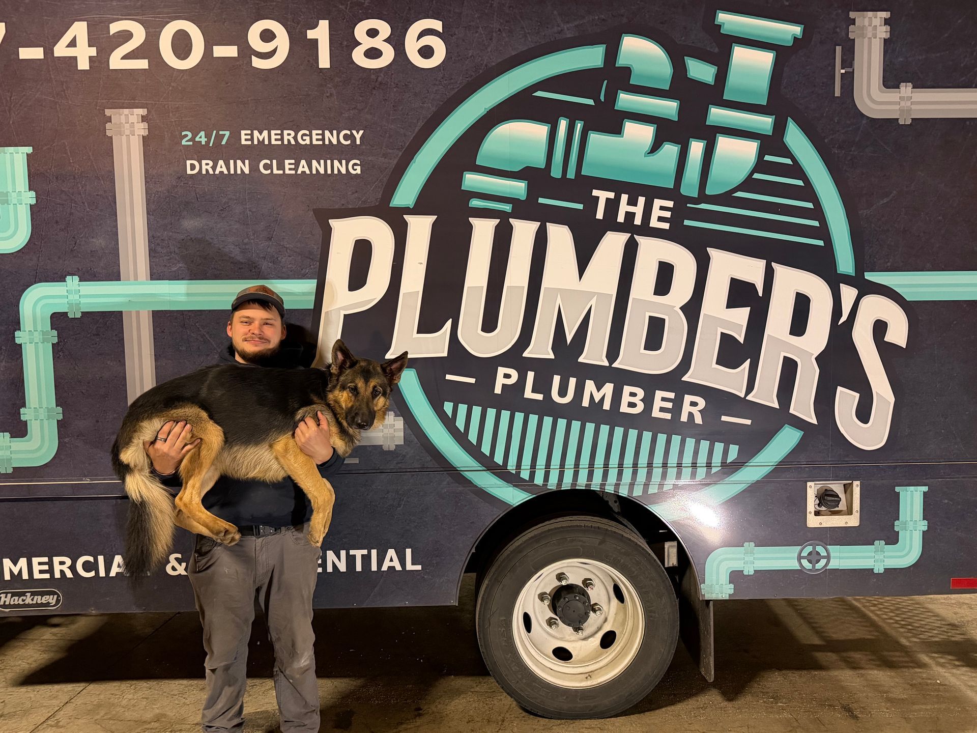 Man holding large dog in front of 