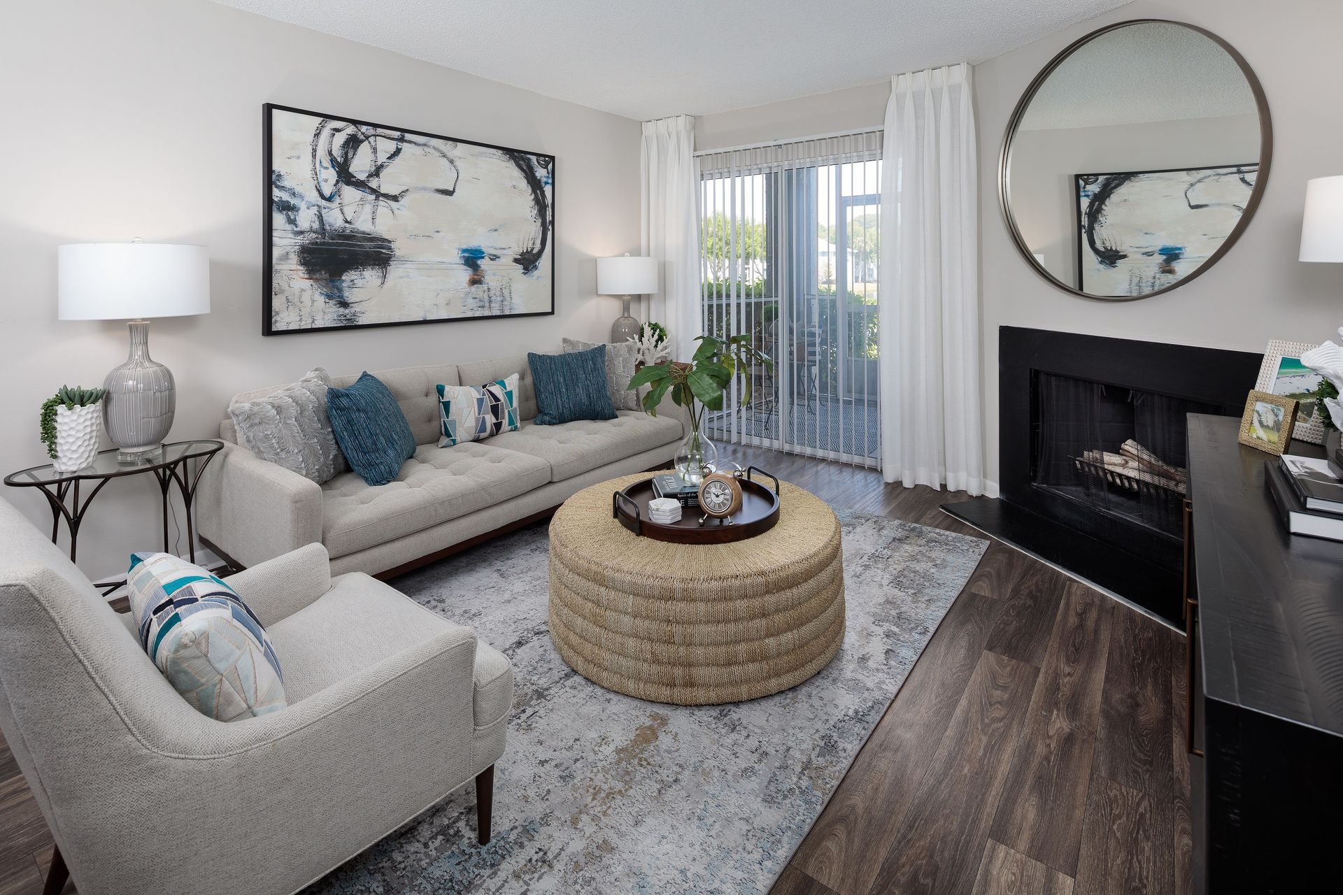 A living room with a couch , chair , coffee table and fireplace.