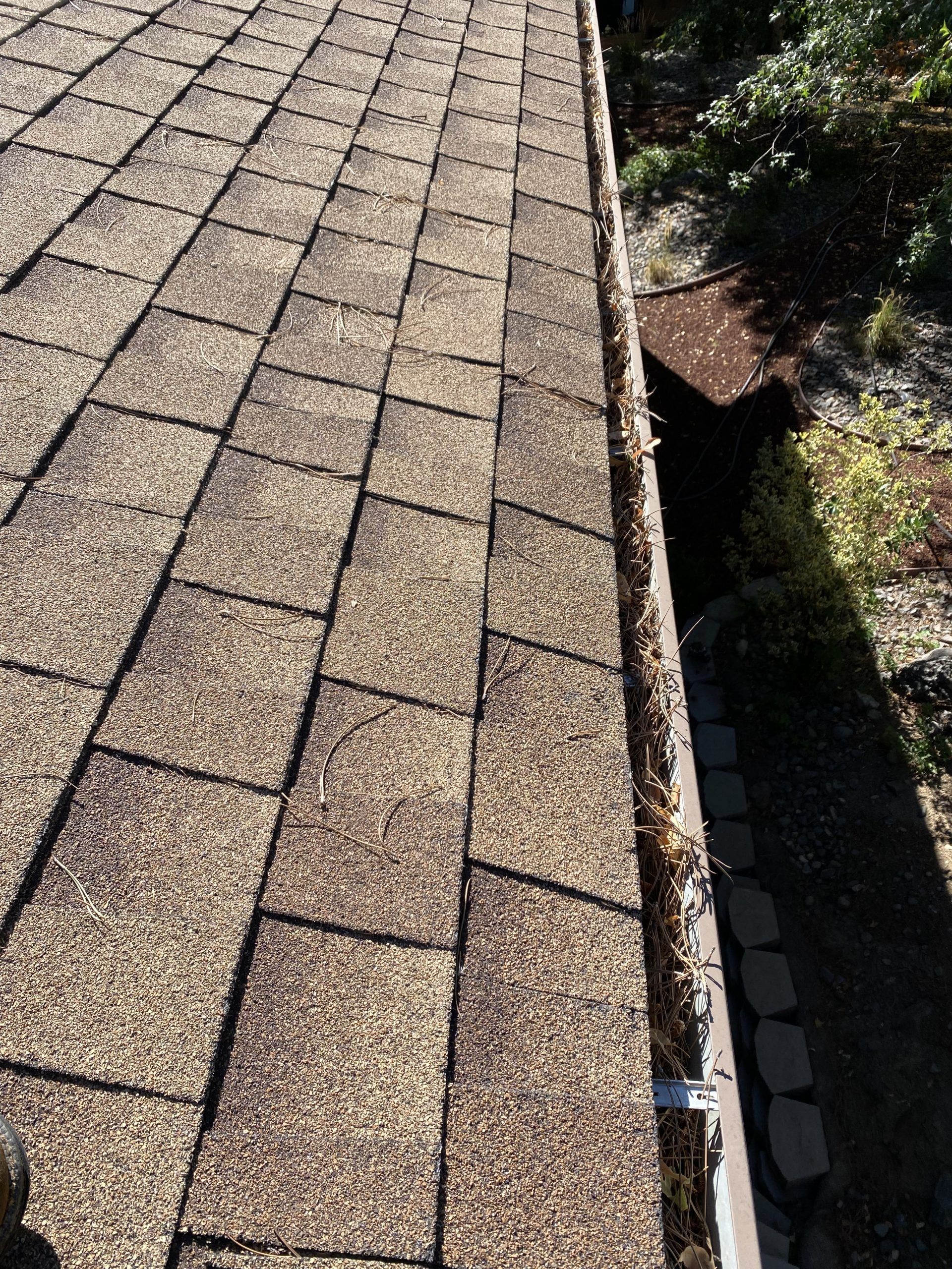 A close up of a roof with a gutter on it.