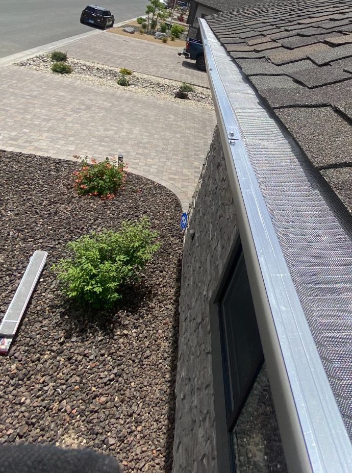 A close up of a gutter on the side of a building.