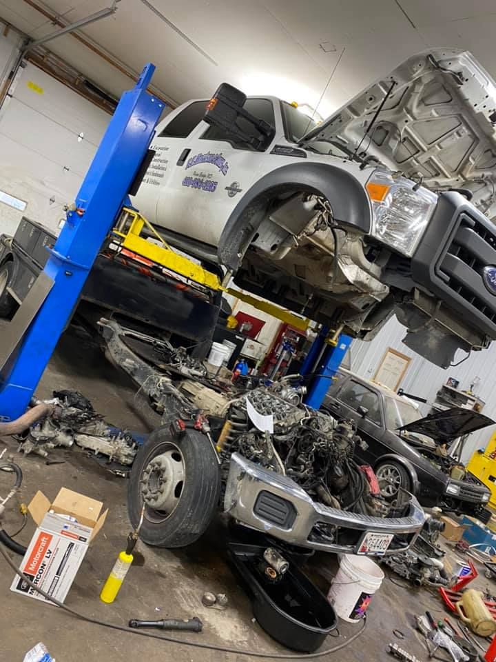 A large truck in a repair shop being worked on | XLR8 Diesel Trucks