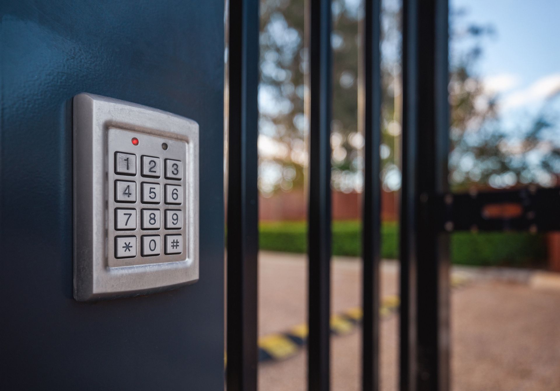 A close up of a keypad on a gate.