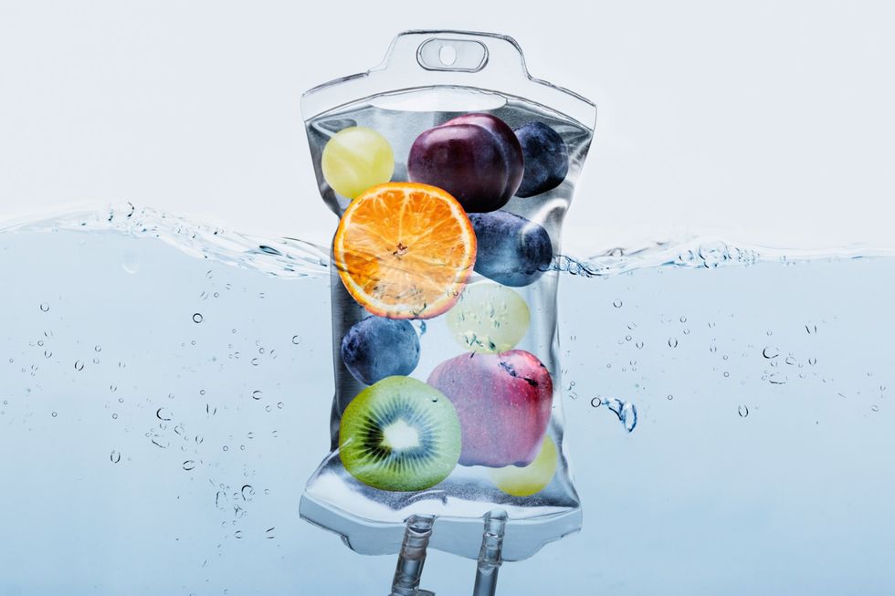 a bag filled with fruit is floating in the water .