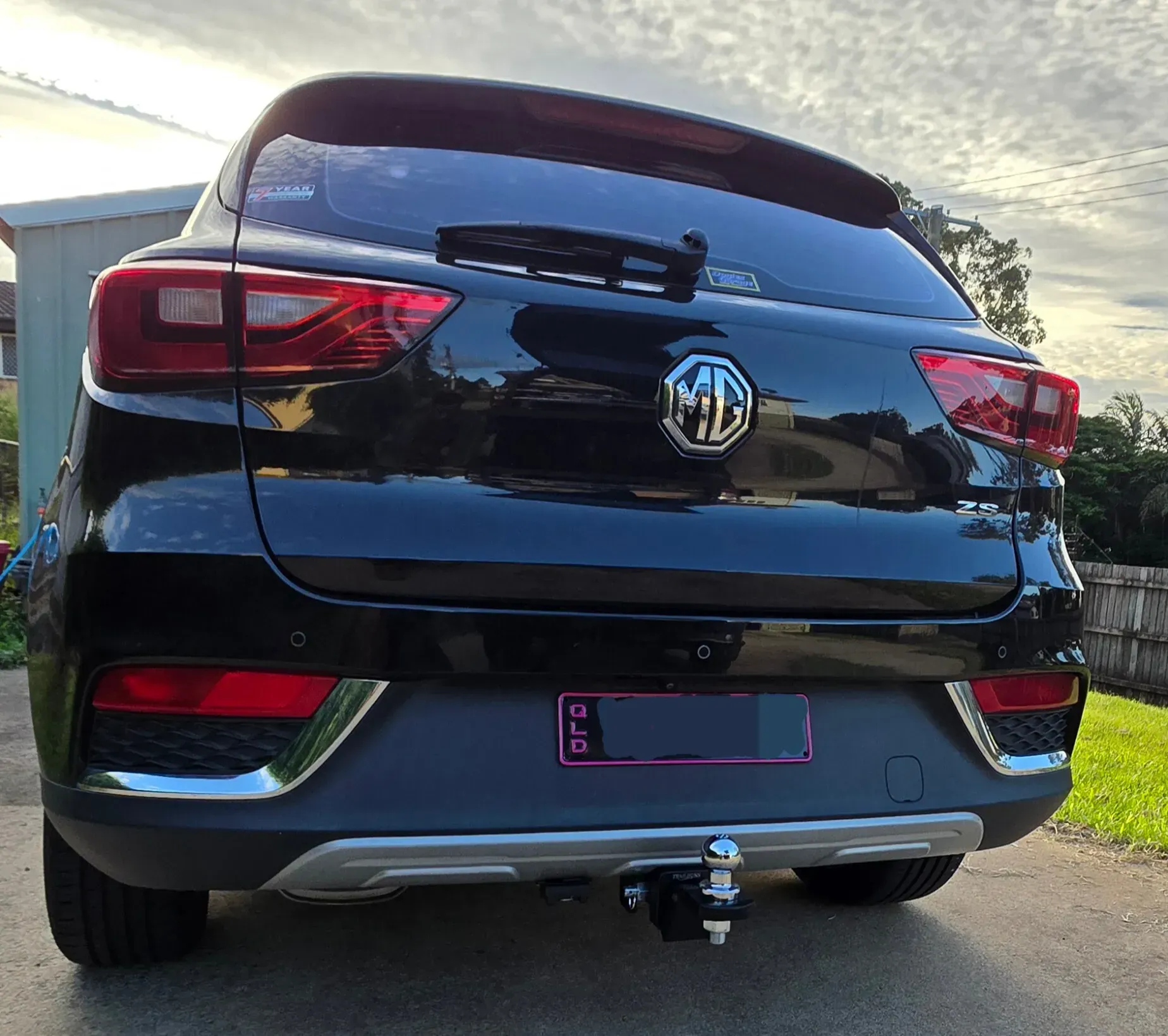 Black MG ZS SUV from the rear, parked outdoors with a tow hitch. Queensland license plate. — Hinterland Towbar & Steel Fabrication In Southside, QLD