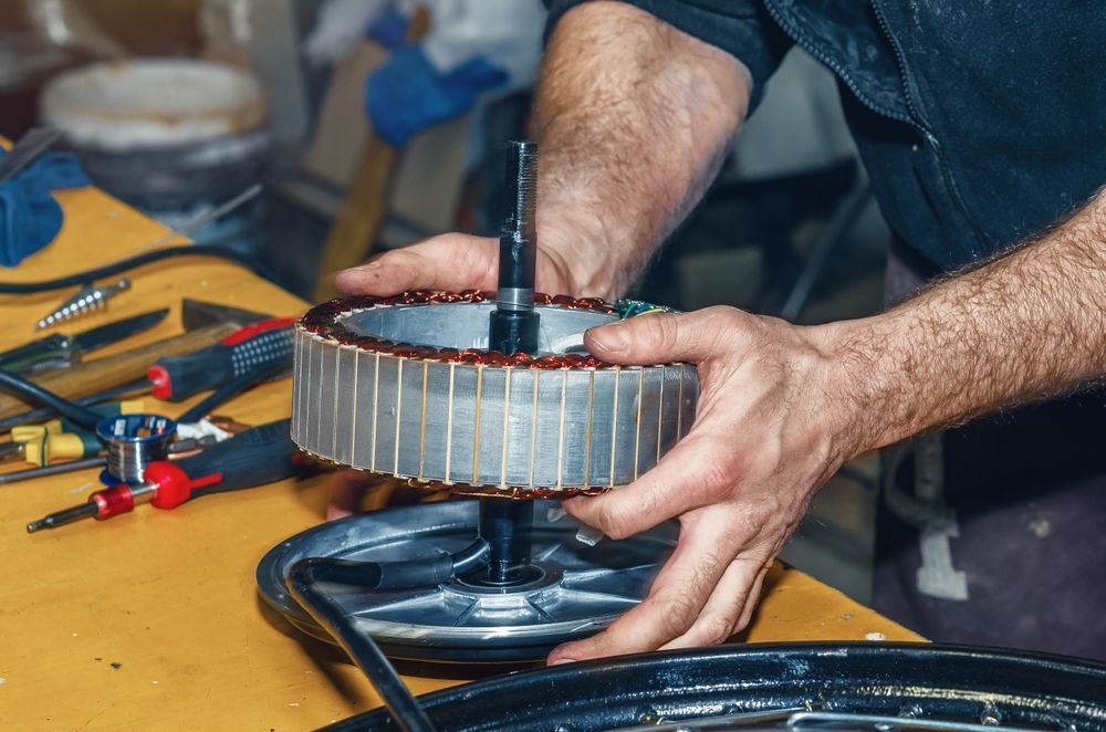 Person Assembling an Electric Motor on a Workbench — Hinterland Towbar & Steel Fabrication In Tin Can Bay, QLD