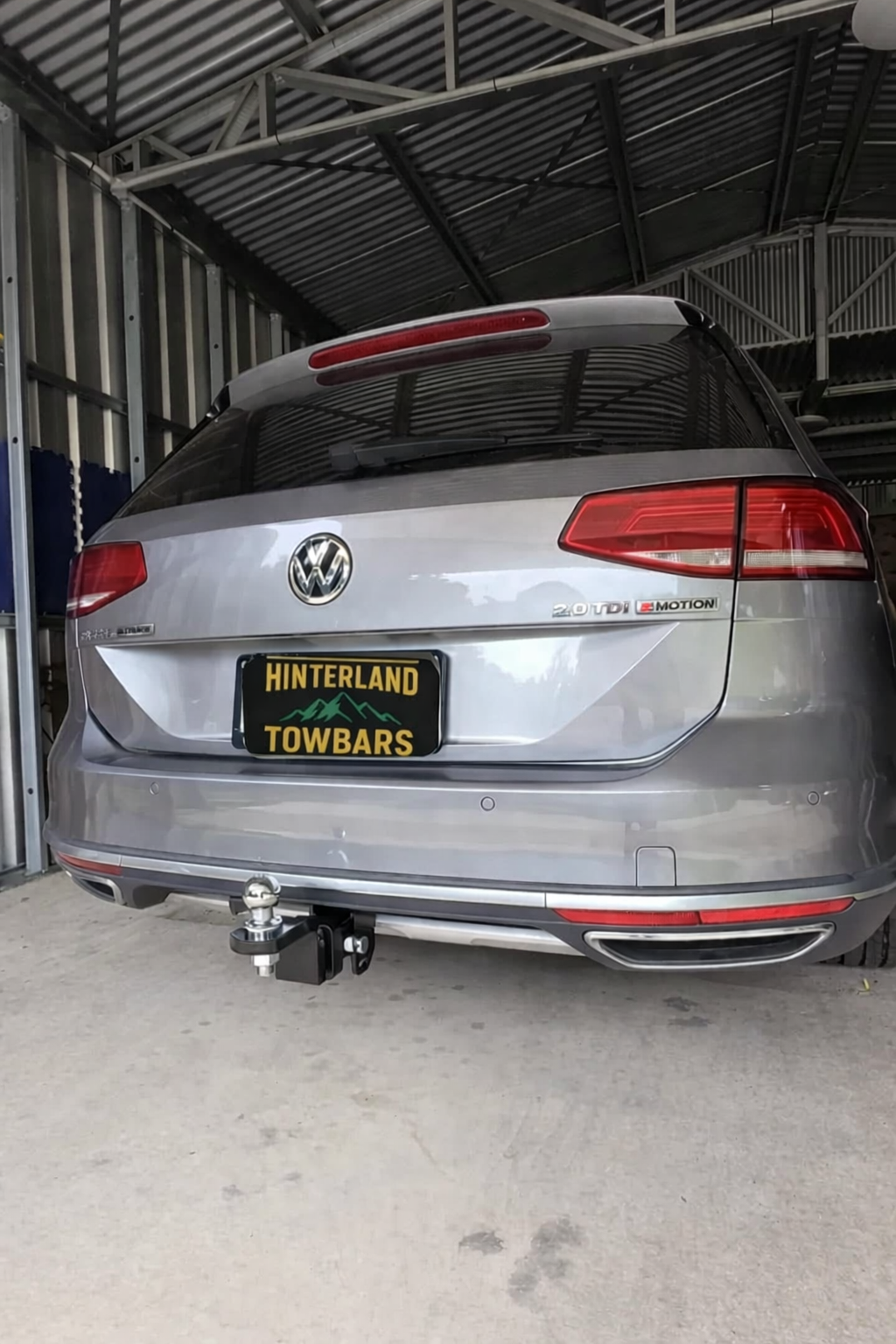 Silver car with a trailer hitch in a garage. — Hinterland Towbar & Steel Fabrication