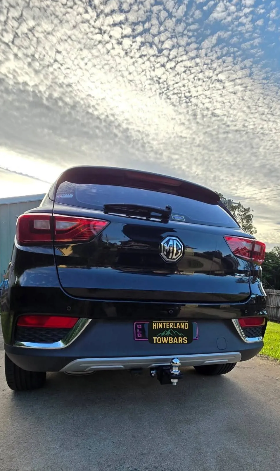 Black Mg Zs Suv Parked, Rear View Against a Cloudy Sky — Hinterland Towbars in Noosa, QLD