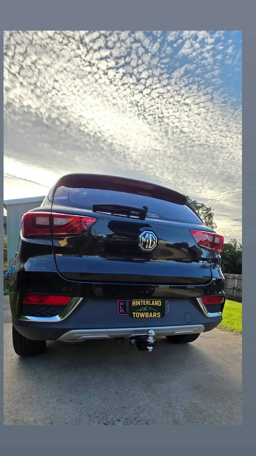 Black Mg Zs Suv Parked, Rear View Against a Cloudy Sky — Hinterland Towbars in Yandina, QLD