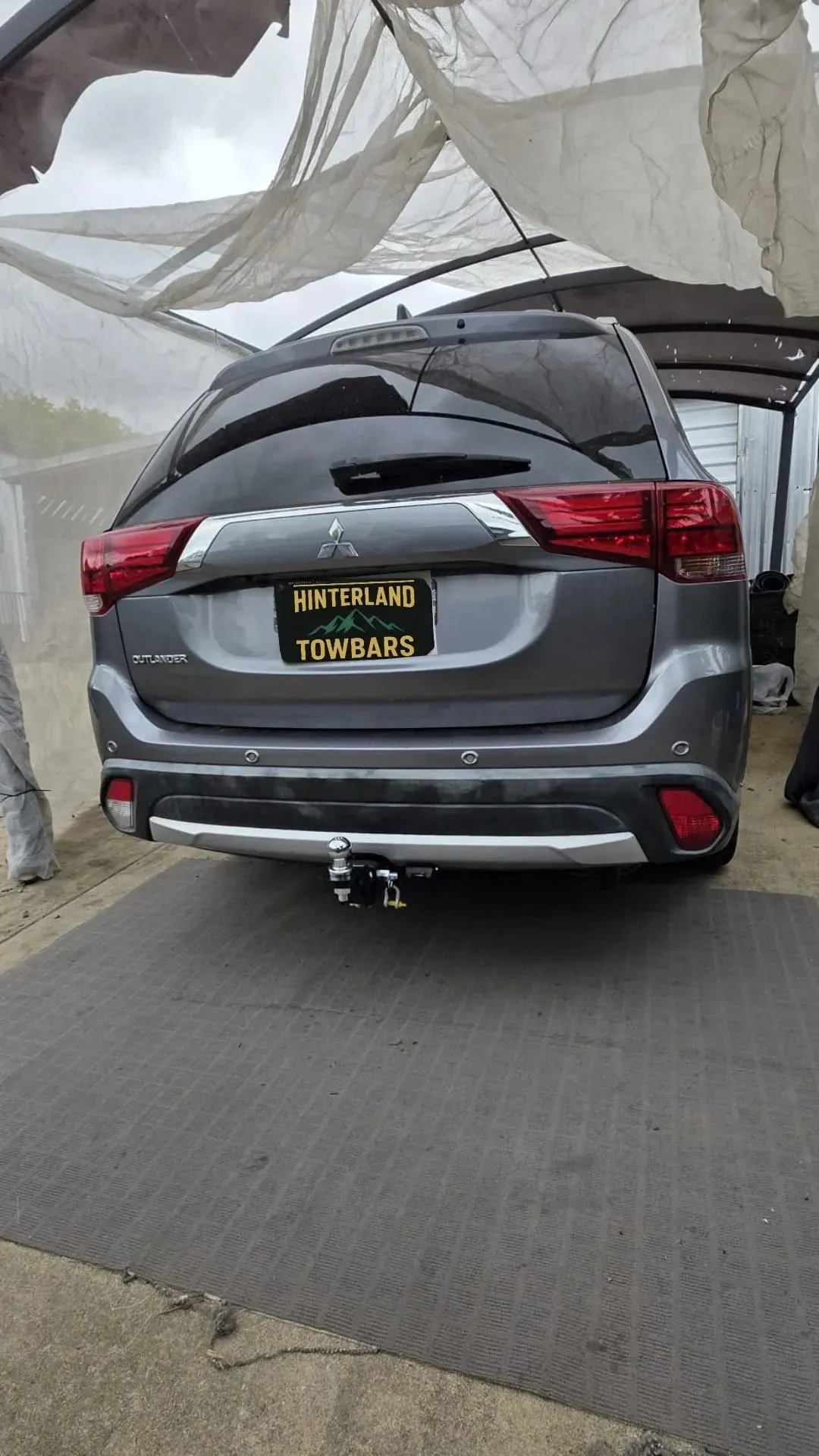 Gray Mitsubishi Suv Parked Under a White Tarp — Hinterland Towbars in Cooroy, QLD