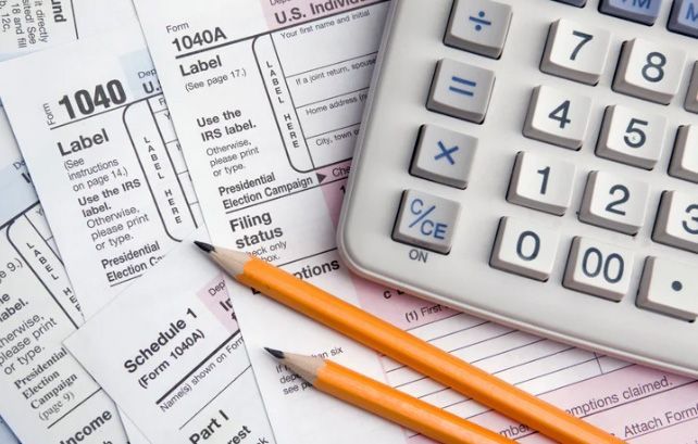 Doctor in white coat consults with patient seated at a table, discussing health.