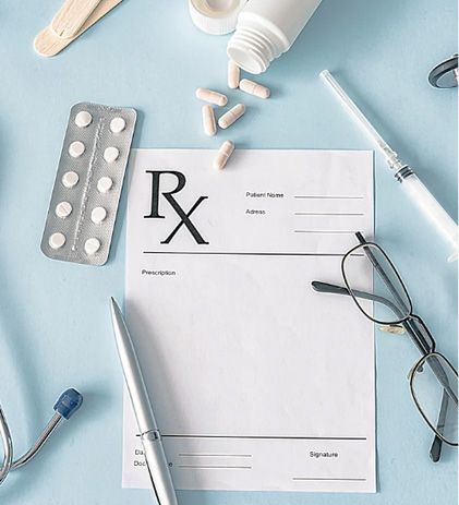 Prescription with pills, medical tools, and eyeglasses on a blue surface.