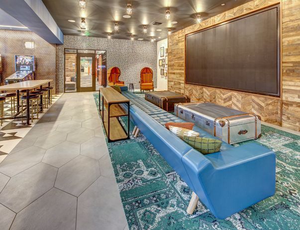 There is a long blue bench in the middle of the room.