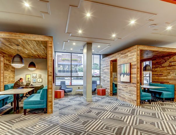 A man is sitting at a table in a restaurant.