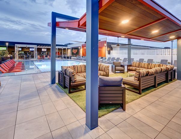 A patio area with a swimming pool and a canopy over it.