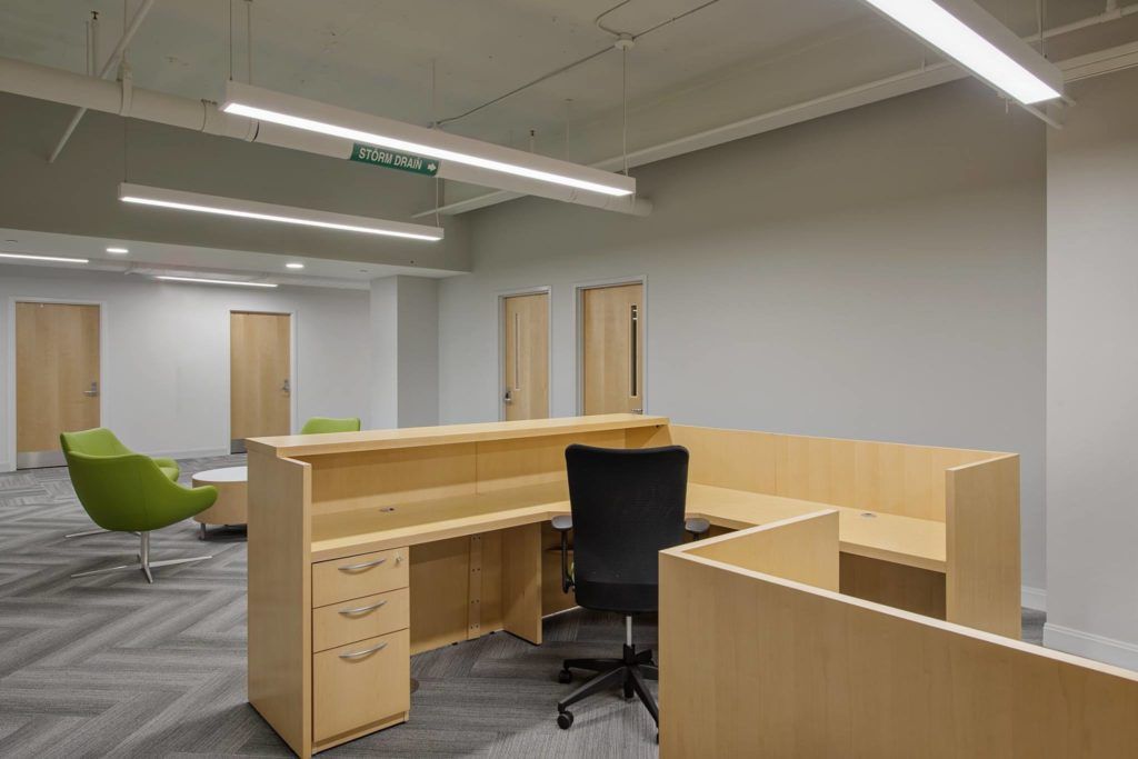 There is a desk and chair in the middle of the room.