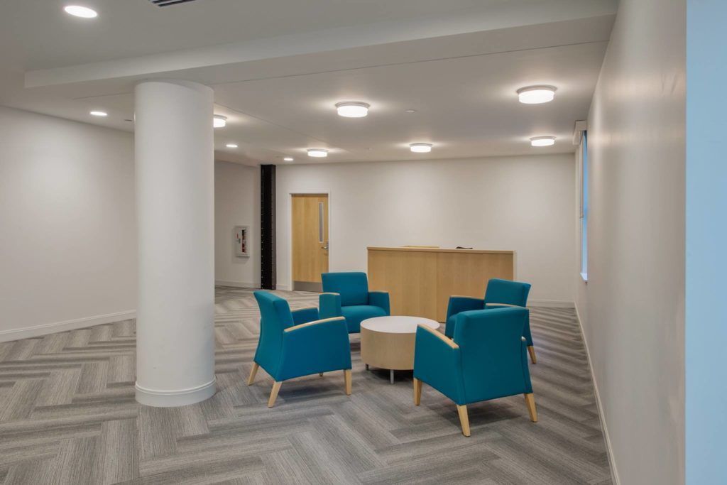 A room with chairs and a table in it.