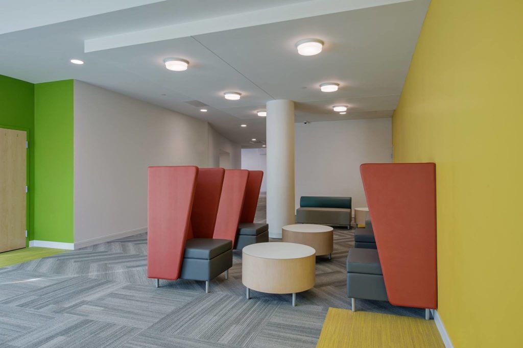 There are a lot of chairs and tables in this room.