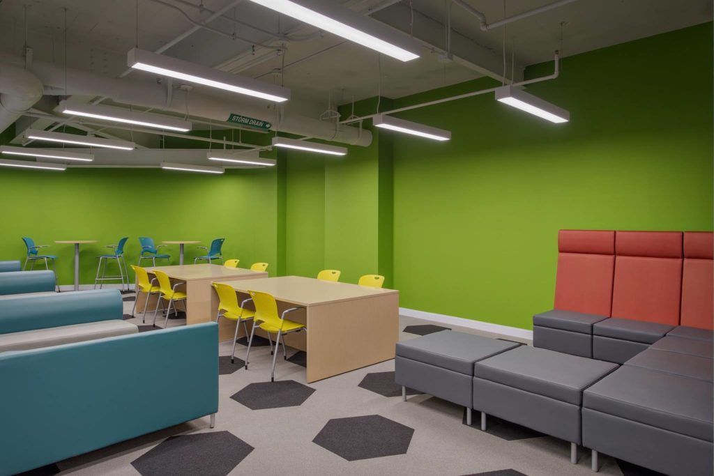 A large room with green walls and a lot of furniture.