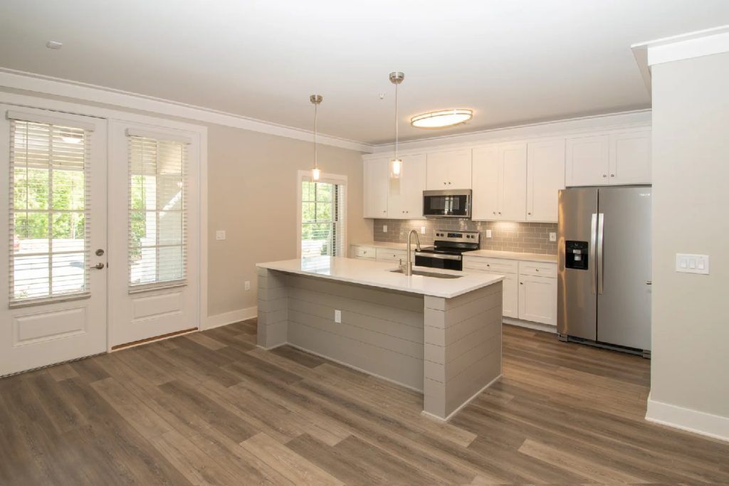 There is a large island in the middle of the kitchen.