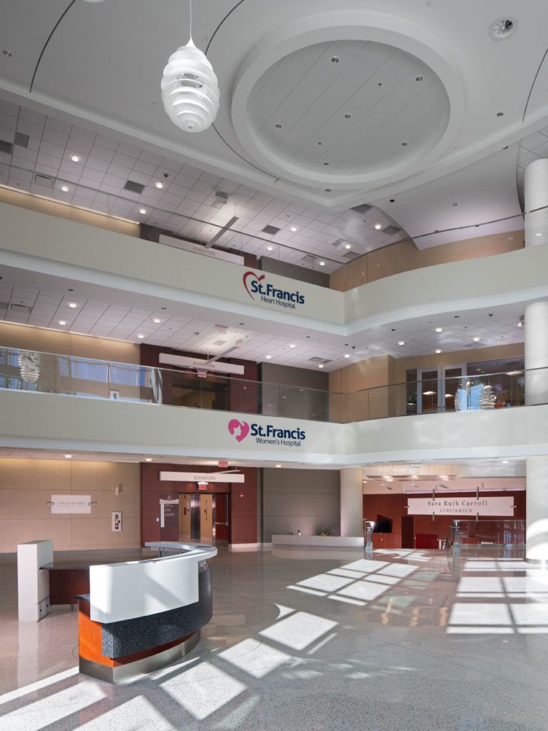 A hospital lobby with a reception desk and a ceiling light