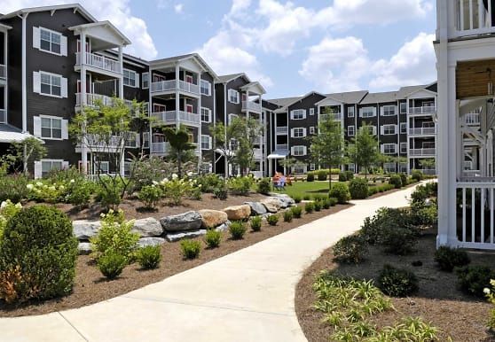 A large apartment building with a walkway leading to it.