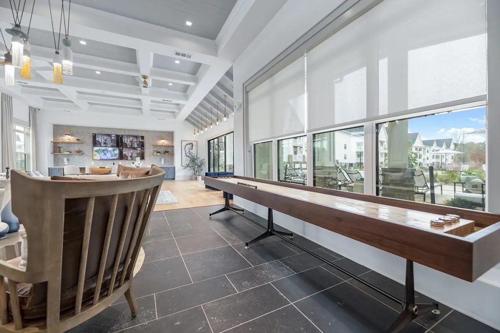 There is a shuffleboard table in the middle of the room.