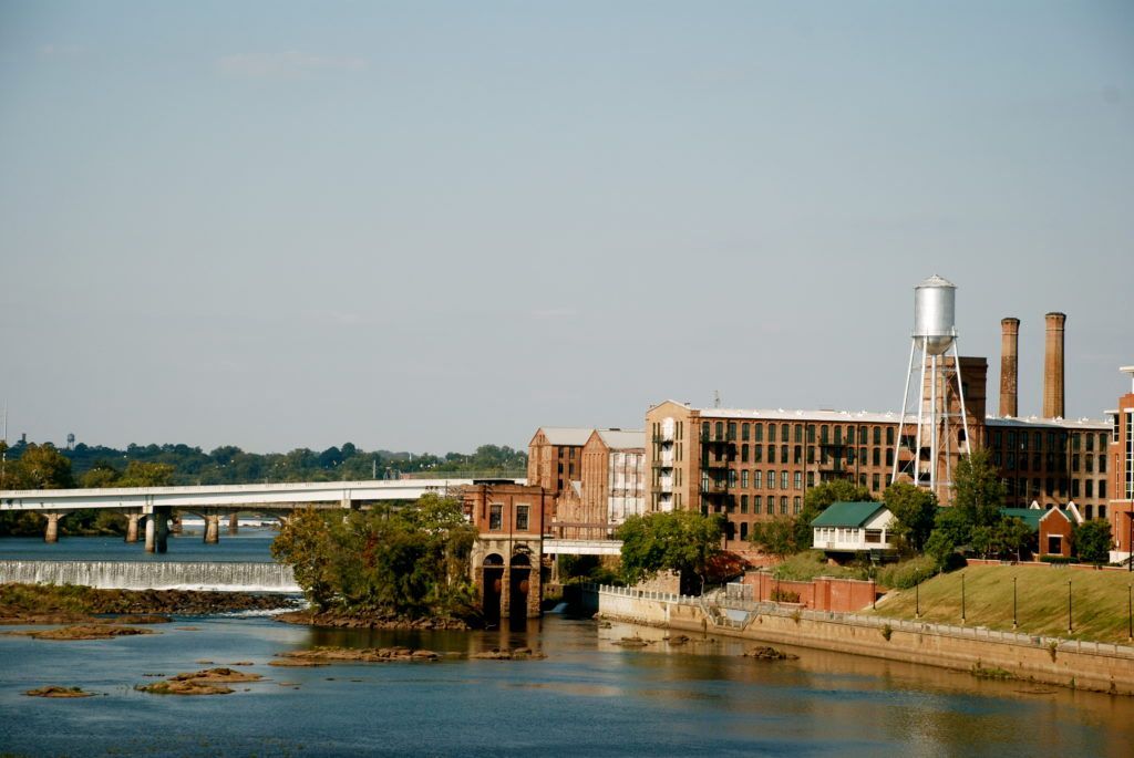 A bridge over a river with buildings in the background