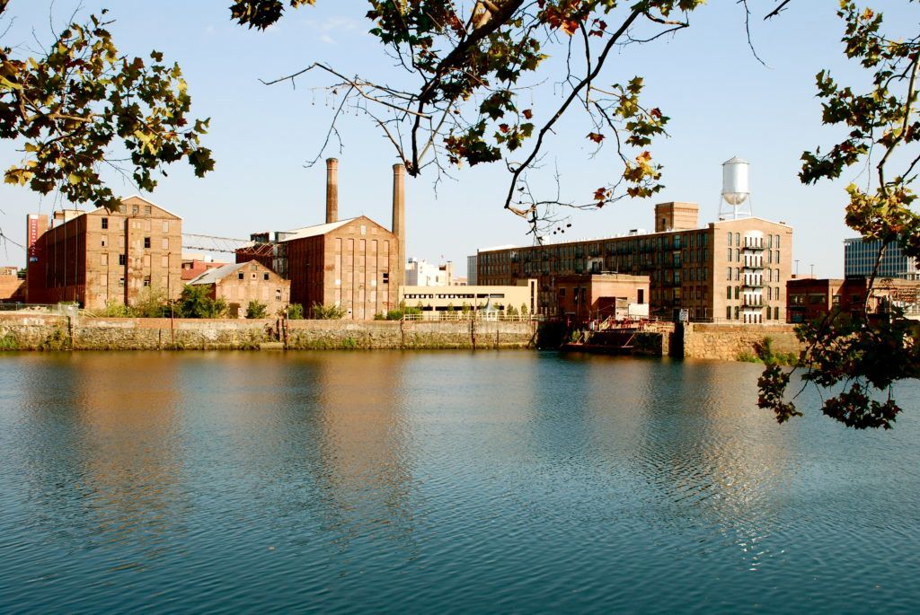 A large body of water with buildings in the background